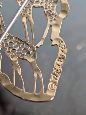 Close-up of a Wild Bryde copyright stamp on the back of a giraffe piece